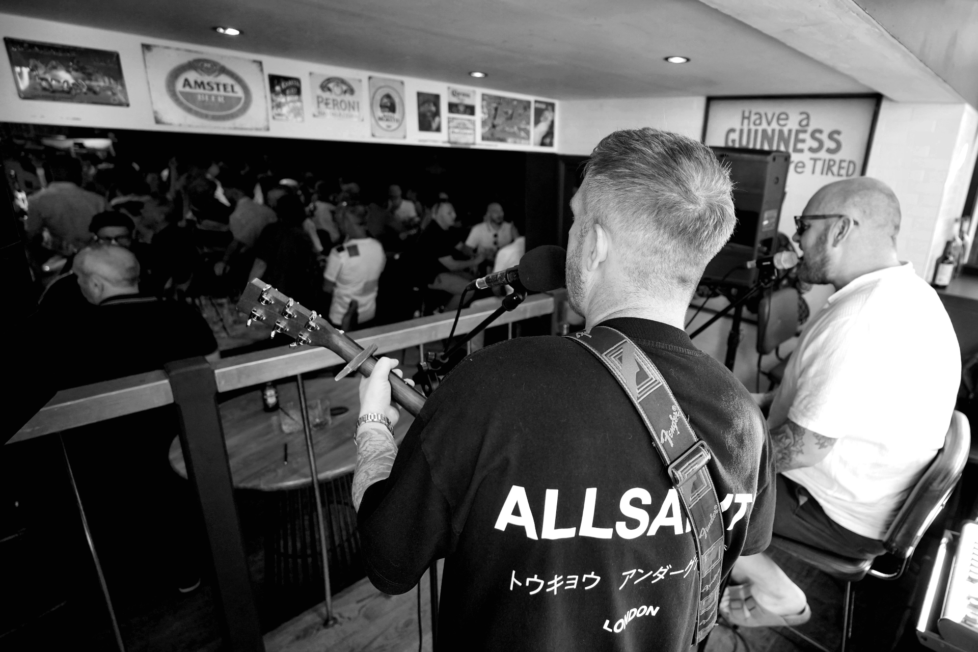 A guitarist performing live in a packed Chester venue