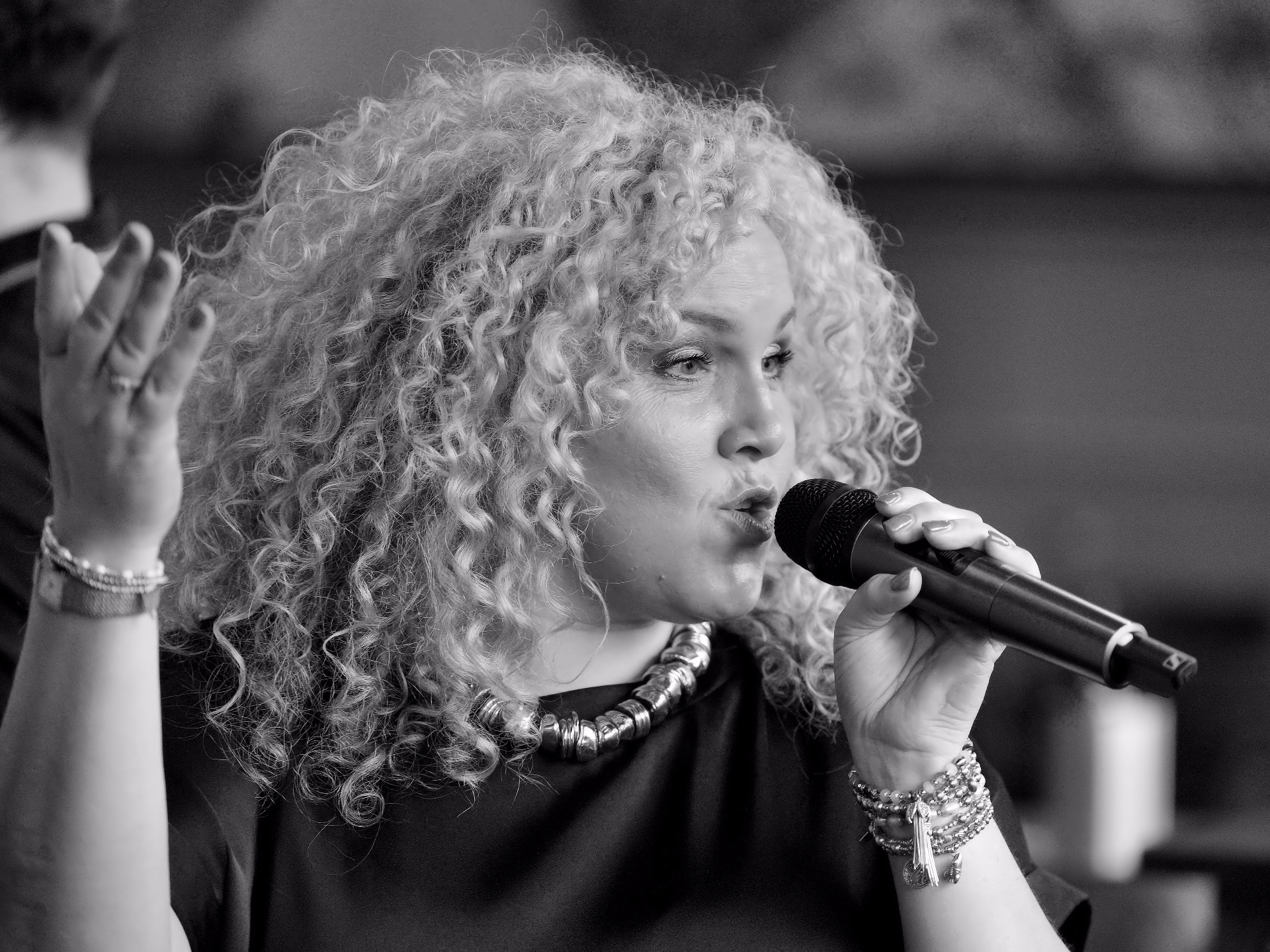 Vocalist mid-performance with microphone